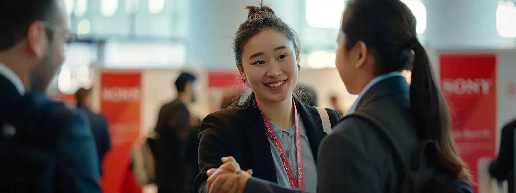 a professional looking individual networking at a real estate conference, shaking hands with industry leaders, surrounded by banners promoting partnership opportunities. a professional looking individual networking at a real estate conference, shaking hands with industry leaders, surrounded by banners promoting partnership opportunities.