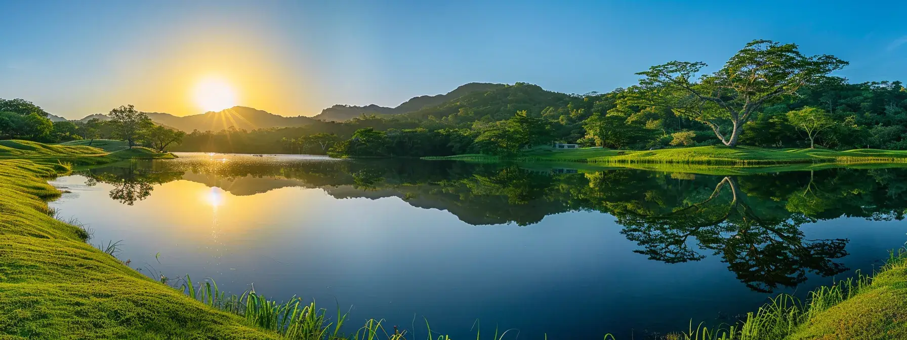 a vibrant sunrise casts golden light over a tranquil lake, perfectly mirroring the surrounding majestic mountains and lush greenery in a serene, reflective tableau.