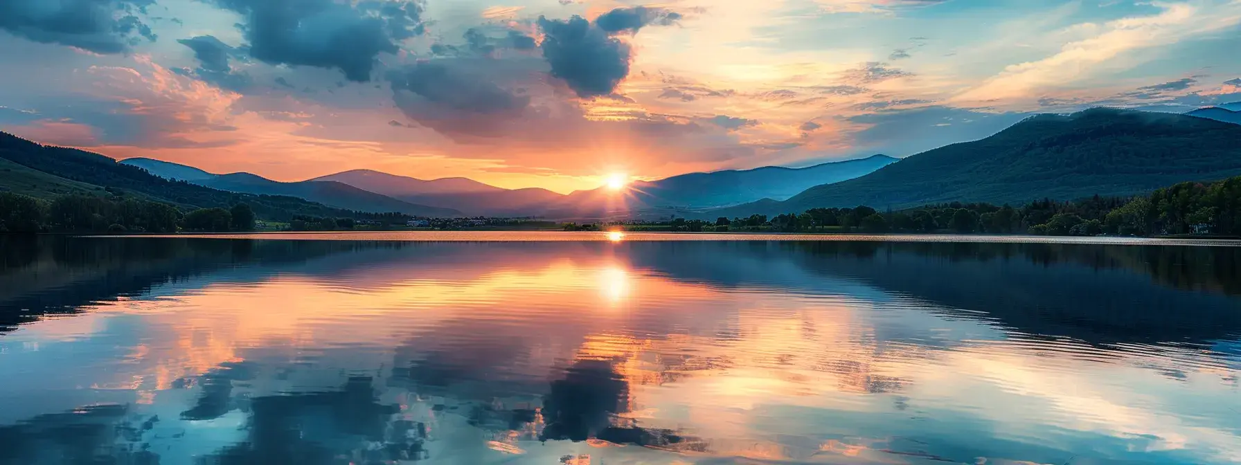 a vibrant sunset casts a golden glow over a tranquil lake, where majestic mountains reflect perfectly on the still water, evoking a sense of serenity and awe.