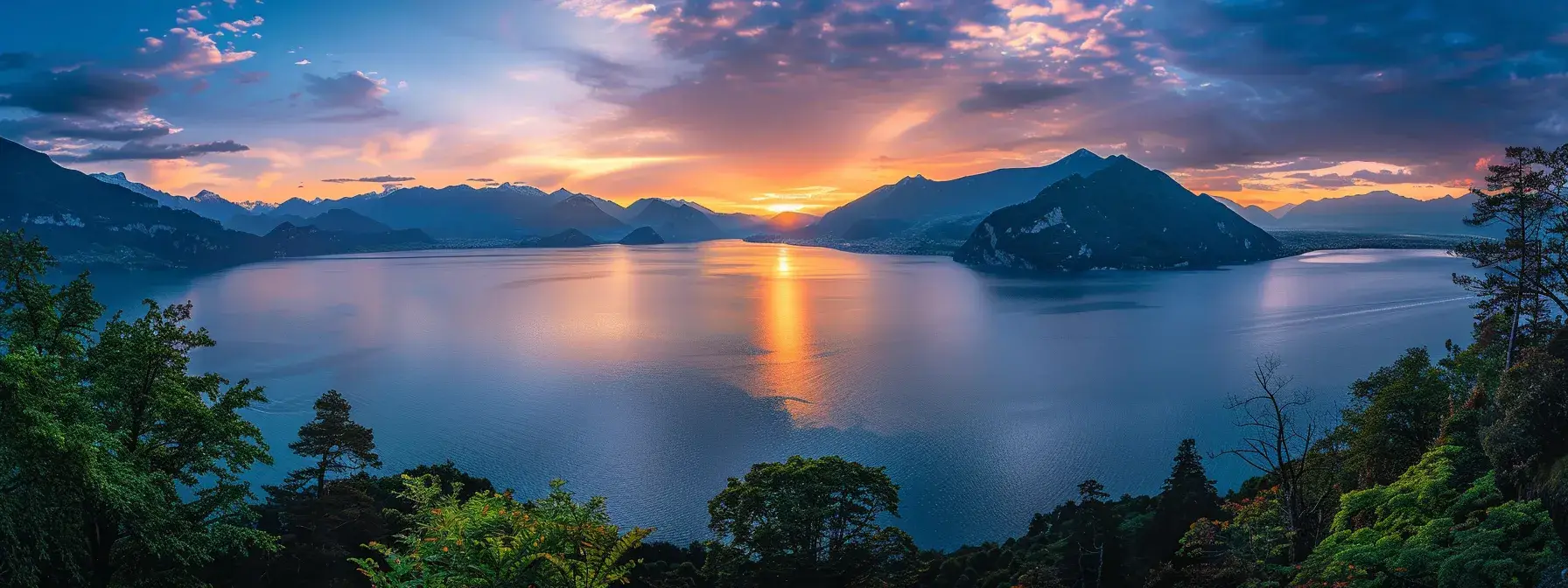 a vibrant sunset casts a warm glow over a tranquil lake, its glassy surface reflecting the cascading colors of the sky, while silhouettes of lush trees frame the serene landscape.