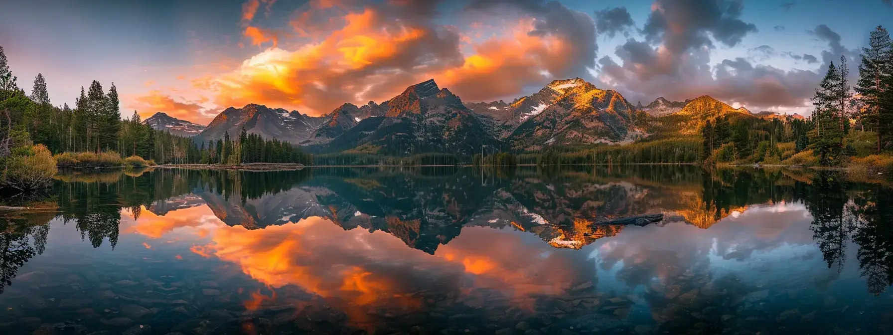 a breathtaking sunset casts a warm golden hue over a serene mountain lake, reflecting the vibrant colors of the sky and the majestic peaks surrounding the tranquil waters.