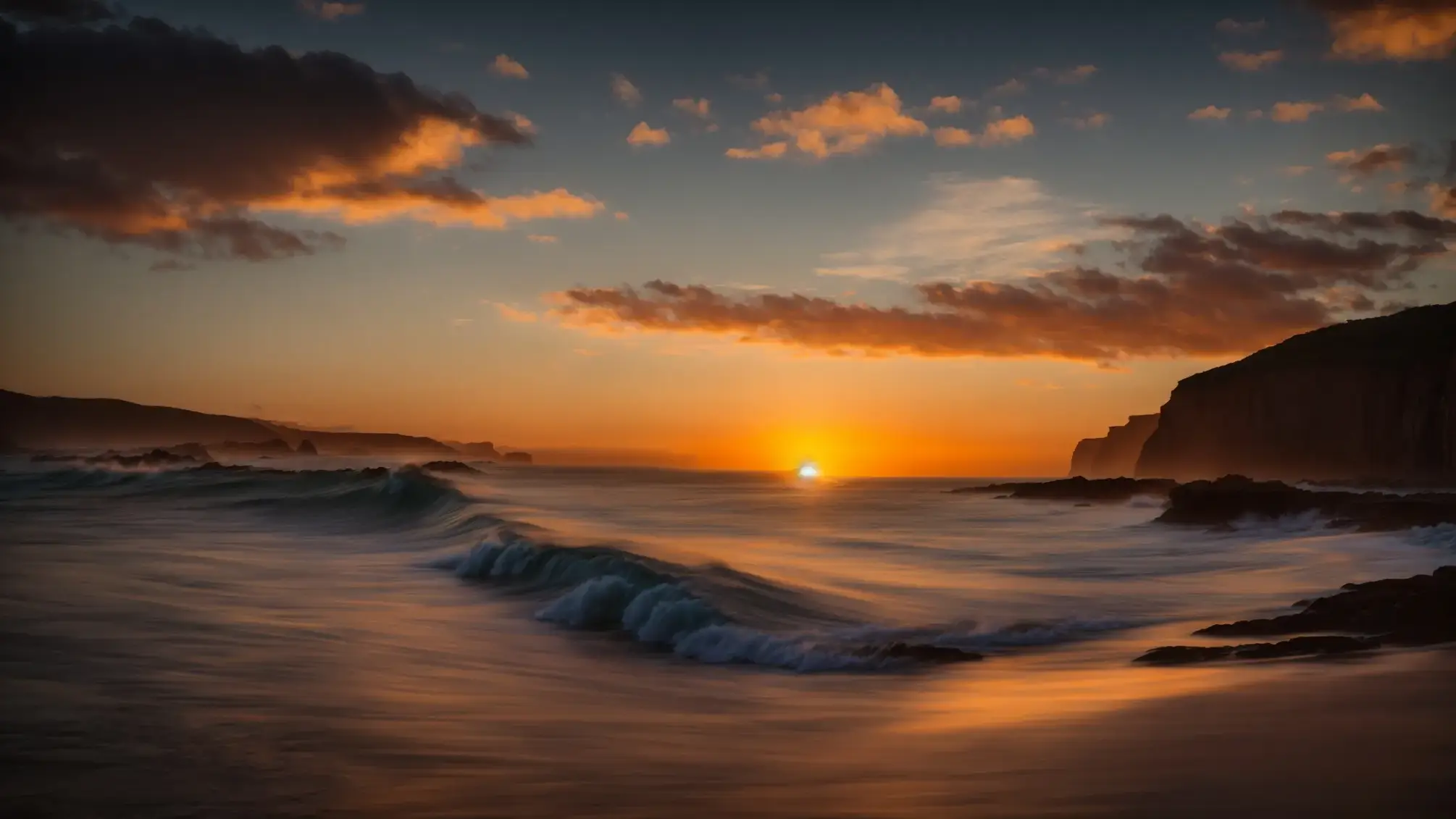 a breathtaking sunset casts golden hues across an expansive ocean, with gentle waves reflecting the vibrant sky as silhouetted cliffs rise majestically in the background.