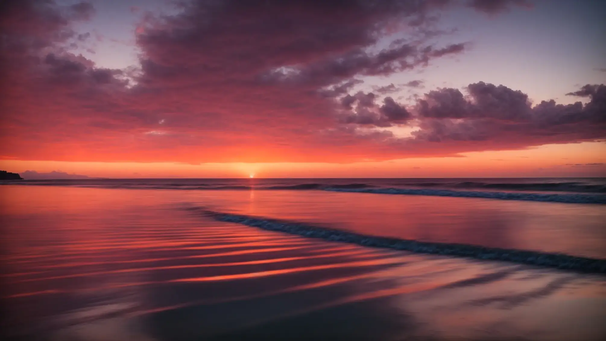 a breathtaking sunset illuminates the calm ocean, casting vibrant hues of orange and pink across the sky and reflecting off the tranquil water, creating a serene and picturesque coastal scene.